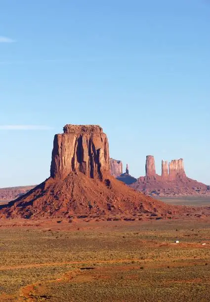 A vertical shot of the popular red-sand Monument Valley on the Arizona-Utah border at sunset