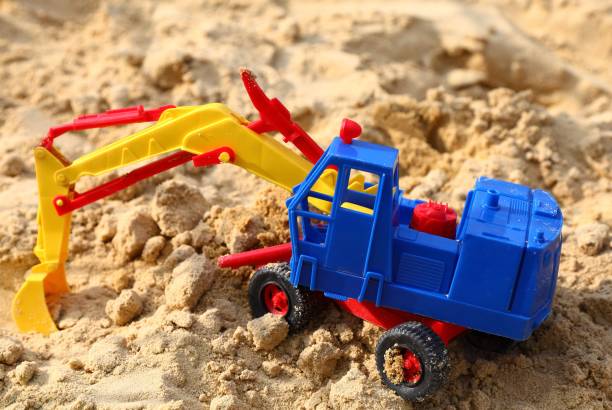 istock Colorful toy excavator on the sand 1445932152