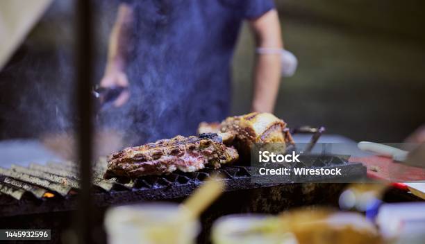 Selective Focus Shot Of Meat Cooking On A Smoking Griller Stock Photo - Download Image Now