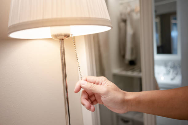 istock Male hand turn off the light on lamp in bedrooom 1445933999