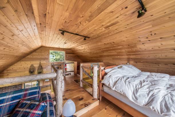 istock Bad with white bedding in a cabin room with a small window 1445934955
