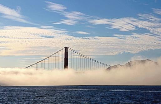 A scenic view of the Golden Gate Bridge in San Francisco, California, enveloped in clouds