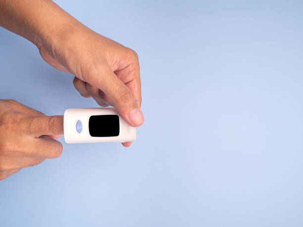 istock Pulse oximeter on the index finger on a light blue background 1445936184