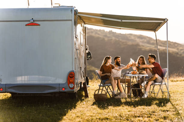 istock Cheerful friends toasting with beer on camping in nature. 1445938169
