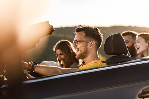 istock Young happy couples going on a road trip by convertible car. 1445938350