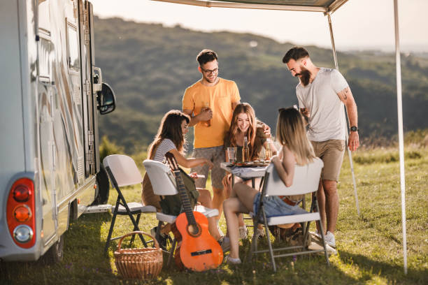 istock Cheerful friends talking while enjoying on camping in nature. 1445939266