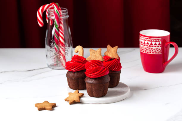 istock Christmas cupcakes with red cream on a white background 1445940554