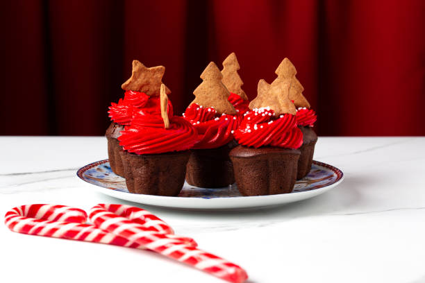 istock Christmas cupcakes with red cream on a white background 1445940665