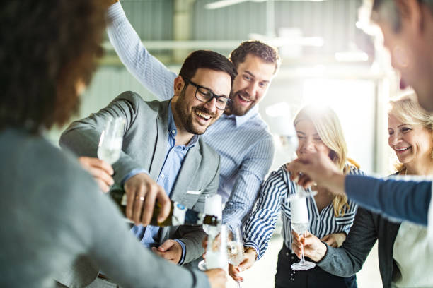 istock Pouring champagne at office party! 1445940882