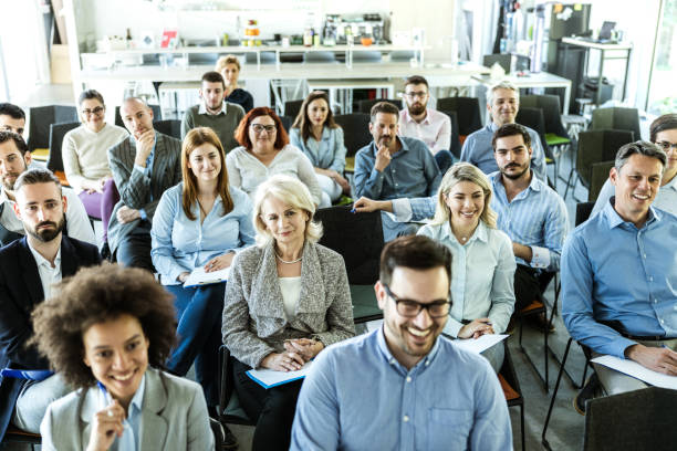 large group of business people attending a training class in a board room. - business seminar writing women imagens e fotografias de stock