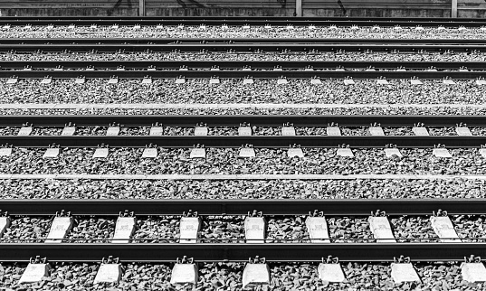 Switches, track systems and overhead lines of a railway line in Germany, monochrome
