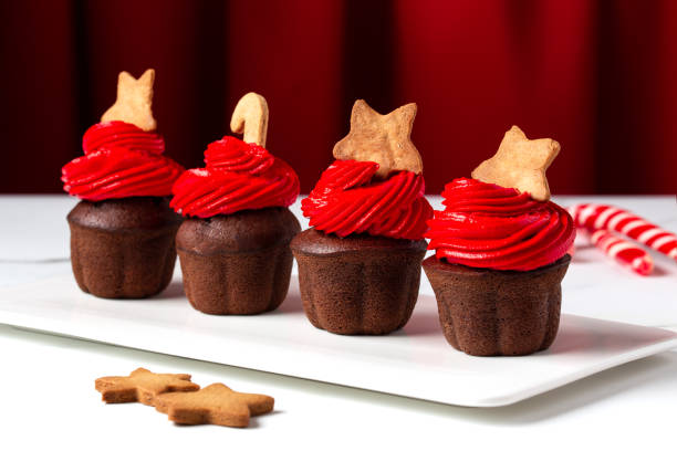 istock Christmas chocolate cupcakes with red cream on a white background 1445942843