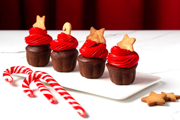 istock Christmas chocolate cupcakes with red cream on a white background 1445943026