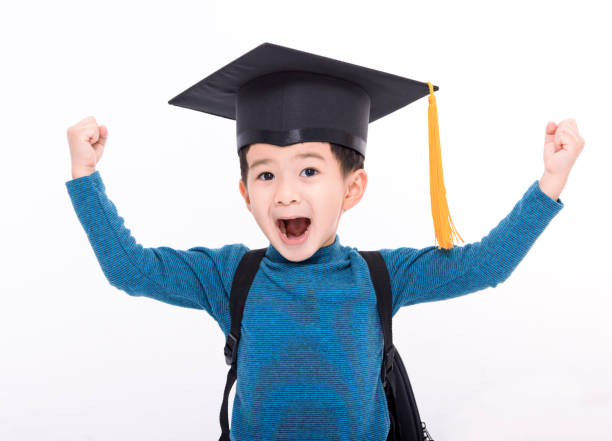 istock Happy little boy student in a graduate cap 1445943397