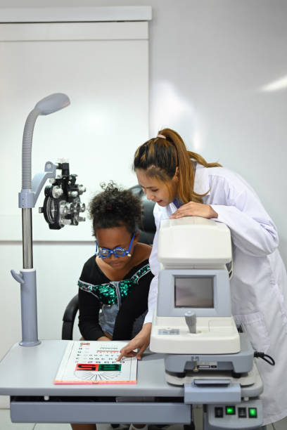 istock Ophthalmologist checking child eyesight with ophthalmology measurements letters, for testing visual acuity. 1445945174