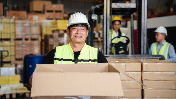 istock Warehouse worker holding box in a warehouse or storehouse. 1445945977