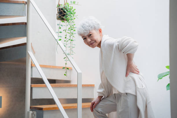 istock Senior woman suffering from back pain on stairs 1445946721