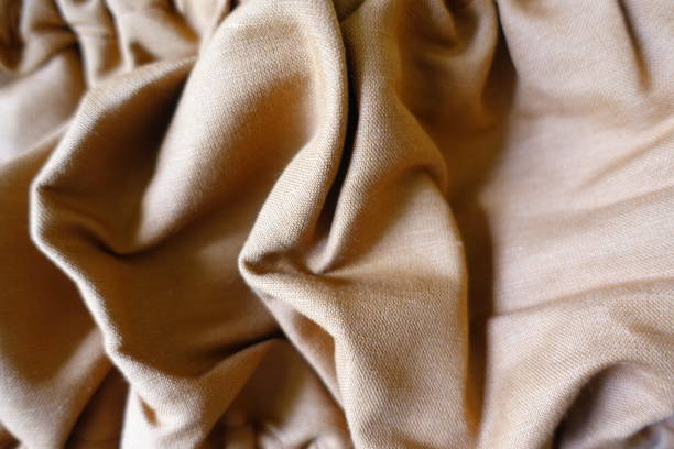 istock Wrinkled dark brown hemp and cotton fabric 1445947770