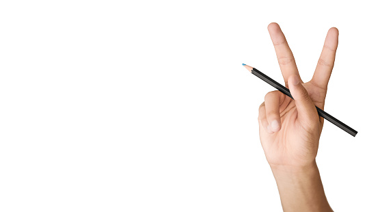 Hand with V sign holding a pencil isolated on white background