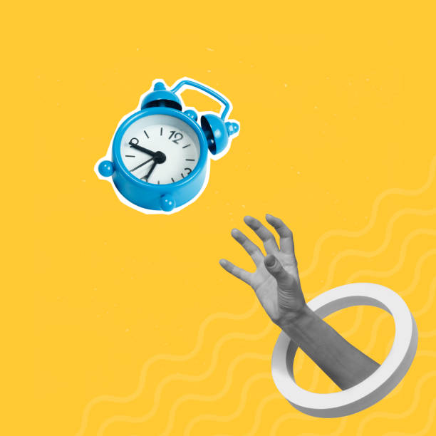 istock Hand catching flying alarm clock on creative abstract yellow background 1445948183