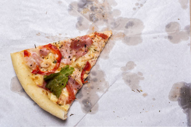 istock slice of fresh pizza on a package on a blue background. Top view, flat lay 1445948792