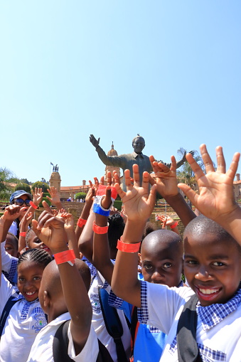 September 29 2022 - Pretoria, South Africa: Happy Children at the Nelson Mandela statue on his square in front of Union Buildings in Pretoria, South Africa