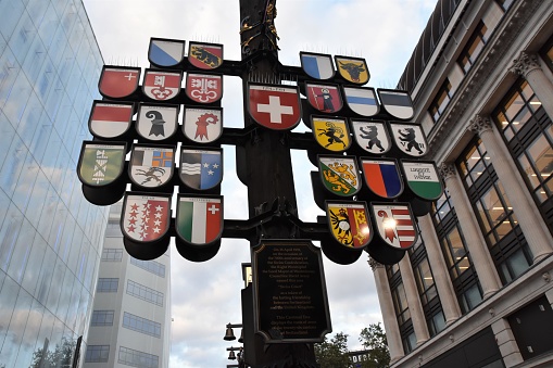 London, UK, 08 13 2016: Coat of arms of 26 cantons of Switzerland exhibited in London Leicester Square in the form of tree.