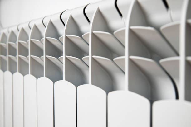 istock White heater on a light wall. Heating and heat concept 1445950240