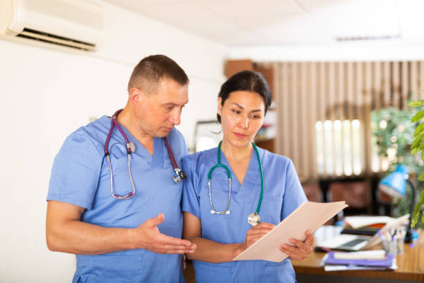 istock Two doctors checking patient papers in clinic 1445950780
