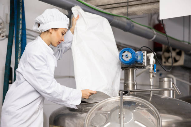 istock Female brewer pours hops into barrel for brewing beer 1445950908