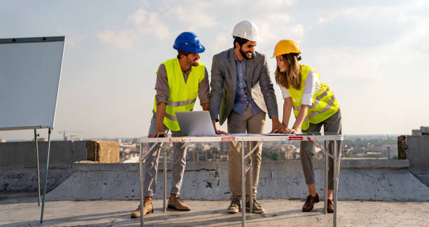 istock Group of engineers, architects, business partners at construction site working together 1445951208