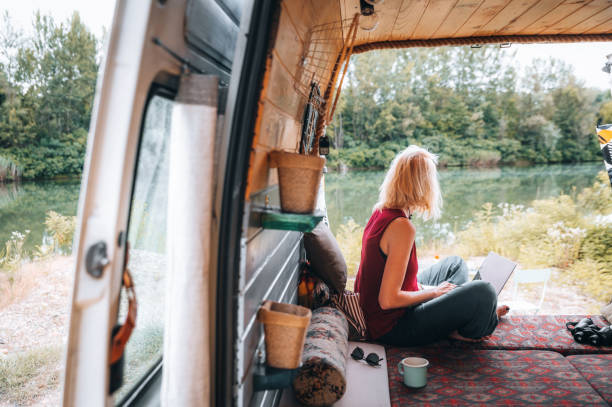 istock Working on her laptop during cozy days in the van 1445954334