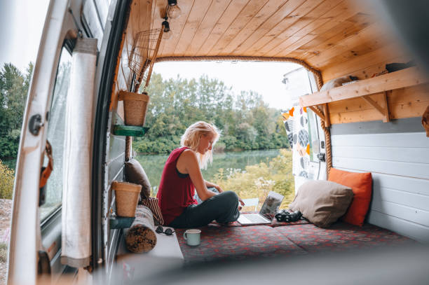 istock Working on her laptop during cozy days in the van 1445954338