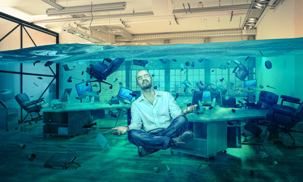 istock man in floating meditation in a flooded office. 1445954777