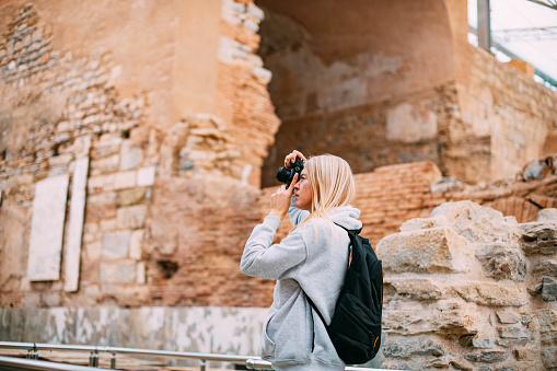 Tourist Woman Walking Around the Ancient City and Taking Pictures