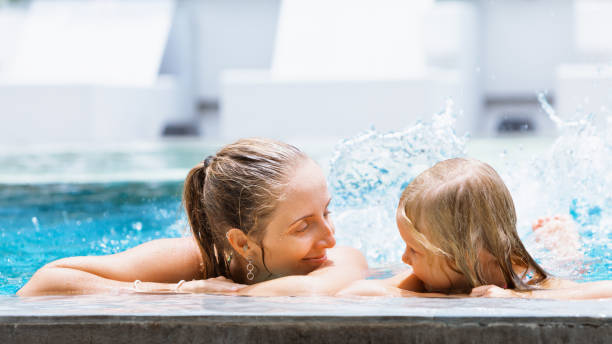 istock Happy people have fun at pool side edge. 1445964865