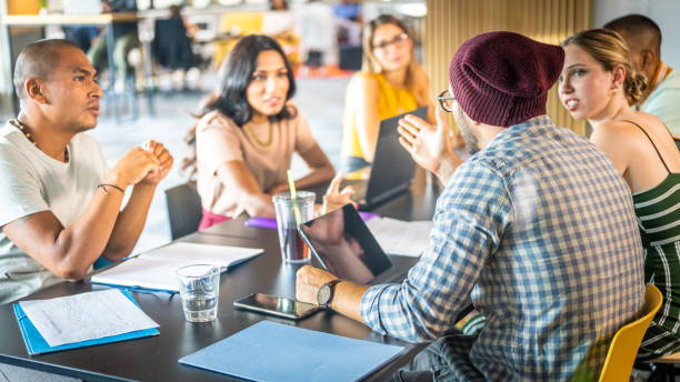 istock Caucasian man with a bonnet using hand gestures at the business meeting 1445969353