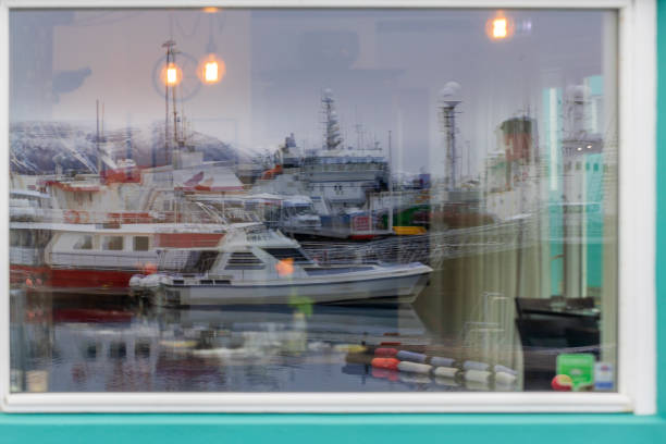 reflection of Reykjavik harbor in the window of a coffee bar stock photo
