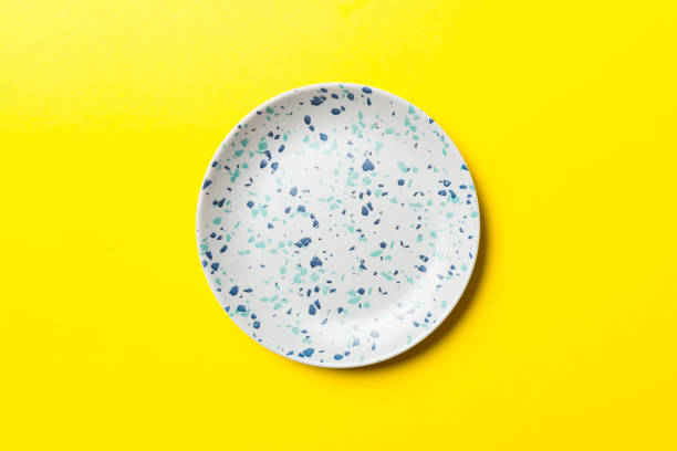 Top view of isolated of colored background empty round blue plate for food. Empty dish with space for your design stock photo
