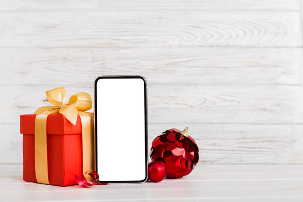 istock Digital phone mock up with rustic Christmas decorations for app presentation with empty space for you design. Christmas online shopping concept. Tablet with copy space on colored background 1445970355