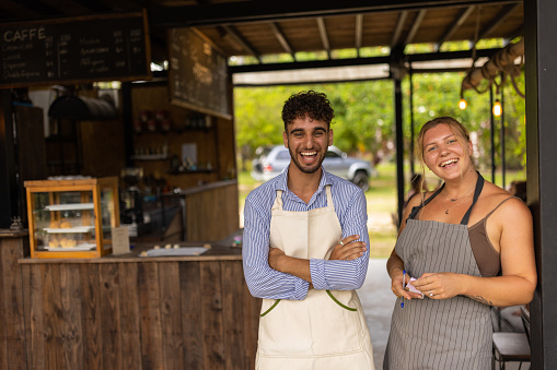 Portrait of multiracial waitress and waiter working together at the coffee shop