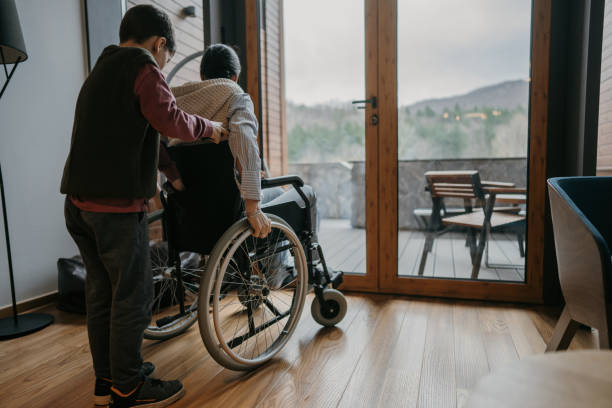 istock Little son helping his disabled mother 1445972844