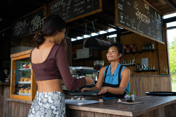 istock Waitress serving the female customer with coffee 1445976269