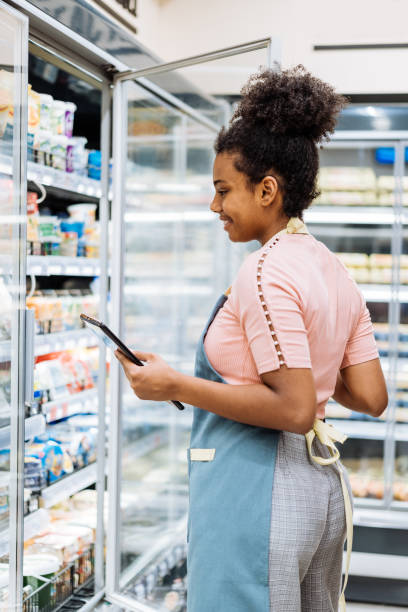 istock Employee in supermarket using digital tablet to organize delivery for supply chain 1445978349