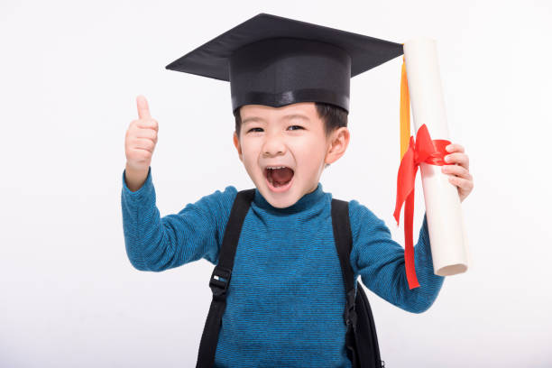 Happy graduate boy student showing the diploma and thumbs up - fotografia de stock