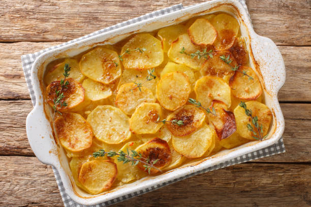 istock French Potato casserole with vegetable broth, herbs, onion and garlic close-up in a baking dish. horizontal top view 1445981908