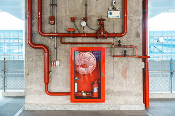 Fire extinguisher and water pump system on the wall, powerful emergency equipment for apartment and hotel