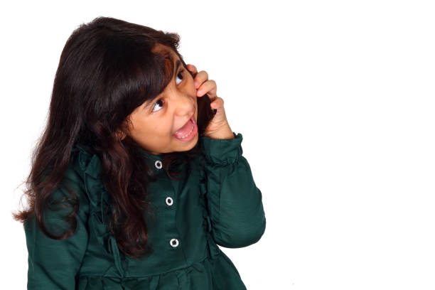 Beautiful asian little girl with phone on white background isolated (6 year old)