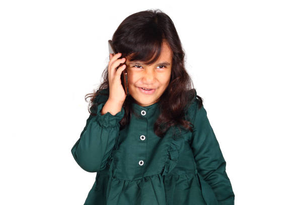 Beautiful asian little girl with phone on white background isolated (6 year old)