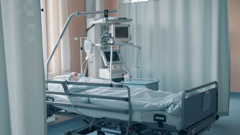 A patient is lying behind the curtain in the clinic unit